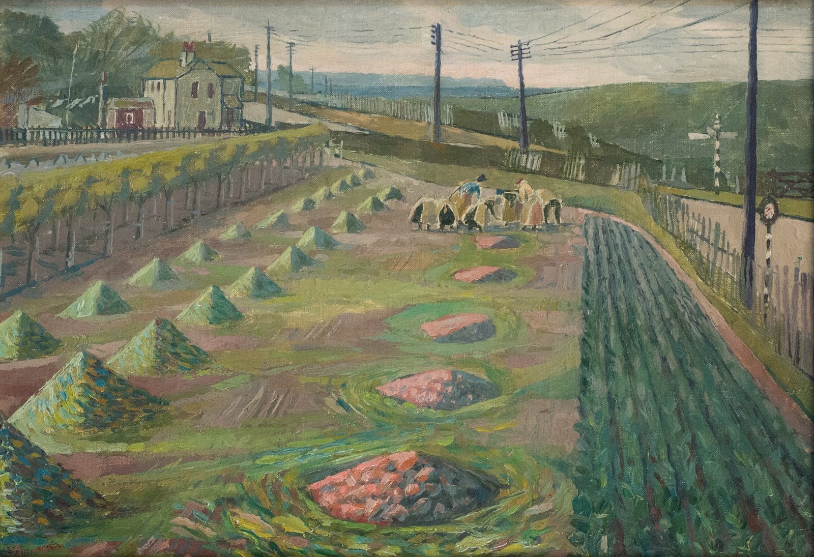 A field with furrowed rows and piles of crops with a group of women working in the distance