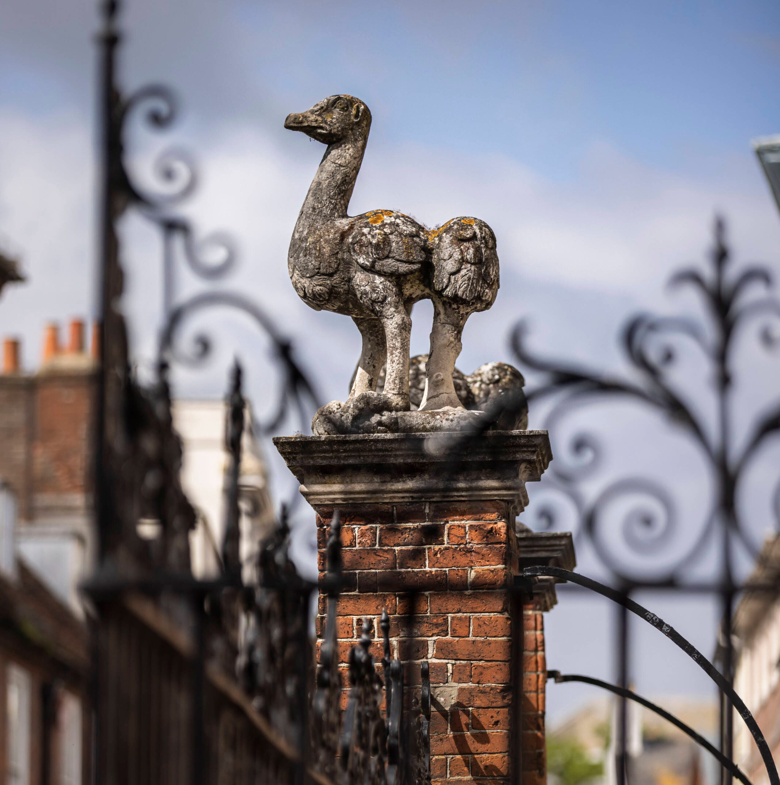 Photograph of outside of Pallant House with focus on stone ostrich sculpture on red brick plinth