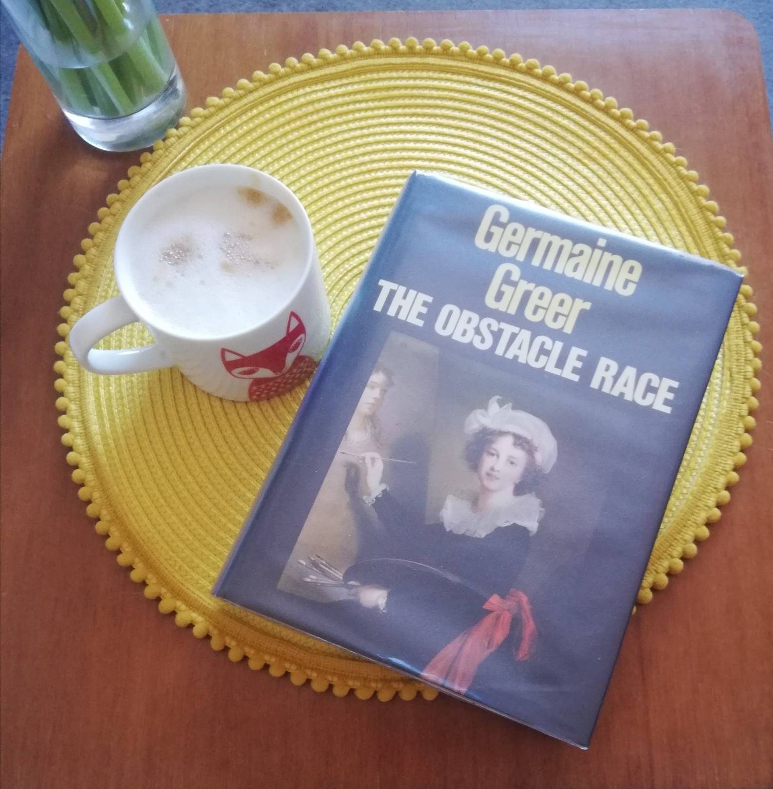 Photograph of the book by Germaine Greer - The Obstacle Race, with a cup of coffee.
